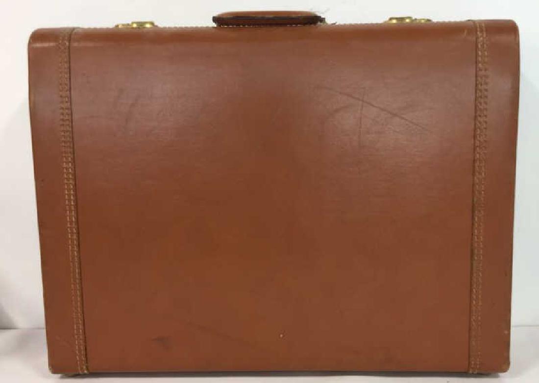 Vintage Siena Toned Leather Suitcase Briefcase: Suitcase appears to be leather. Has a siena tone. Has suitcase handle and gold toned accents. Interior has some stains. Measures approx 18 inches tall 23 inches wide 6 inches deep.briefcase, carry all