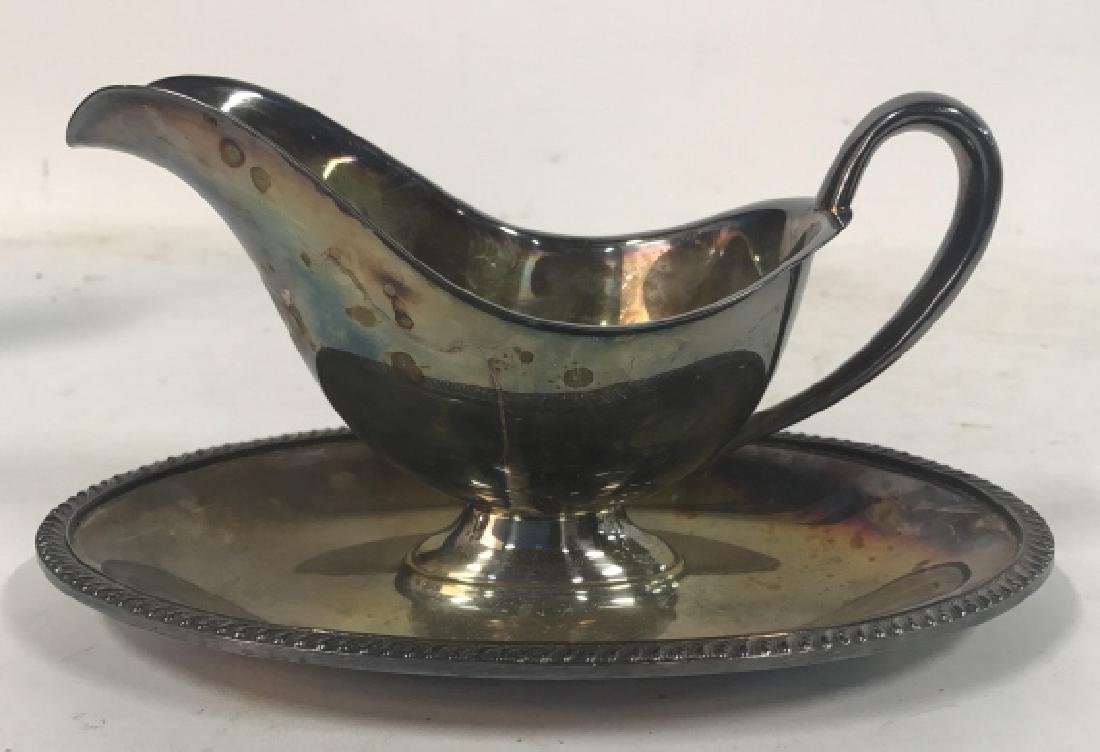 Silver Plate AVON WM ROGERS Gravy Boat: Plated Avon Wm Rogers #3613 gravy boat with ridged edges and a handle. Contains some discoloring. Measures approx 4 inches tall x 9 inches long x 5.5 inches wide. Decorative silver plate table top acc