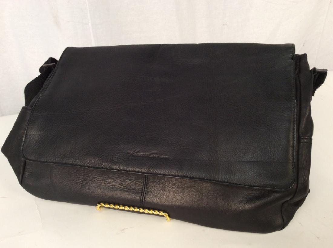 KENNETH Cole Black Leather Shoulder Bag: KENNETH Cole Black Leather Shoulder Bag, 17 in x 12 in, good condition, original tags, Calf skin with clothe interior, flap embossed with Kenneth Cole, possibly a computer bag, fabric adjustable shoul