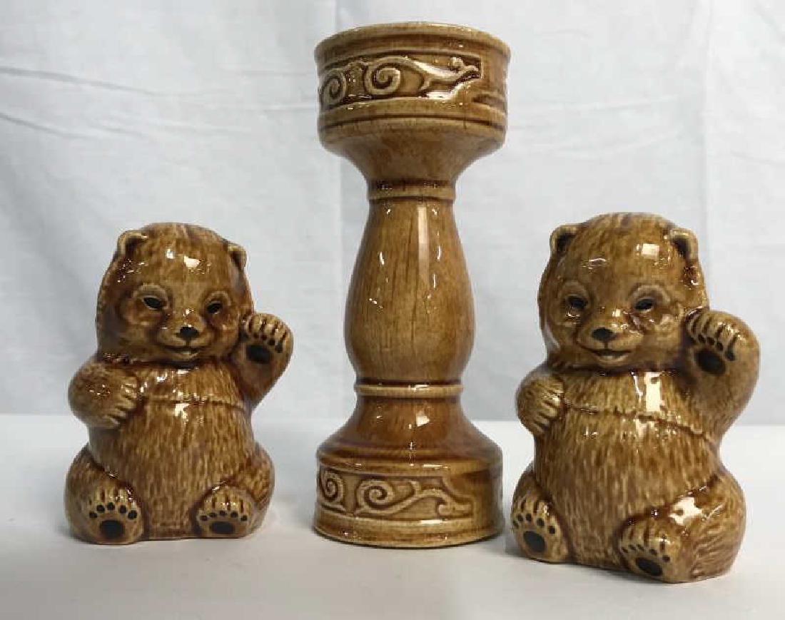 Set of 3 Glazed Ceramic Tabletop Accessories: Set of 3 glazed ceramic tabletop accessories, including a candlestick holder and two waving bear figurines. Each piece is caramel in tone. The candlestick holder is approx 5.25 inches in height by 2 i
