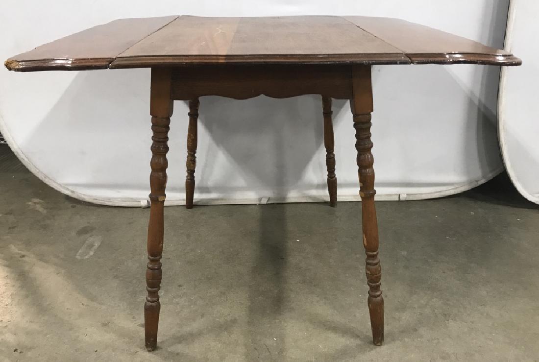 Vintage Drop Leaf Table W Turned Splayed Legs: Vintage Wooden Drop Leaf Table W Turned Splayed Legs, scratches to surface, damage to legs and edges of table, measures approximately 42 inches wide when leaves up x 36 inches deep x 30 inches tall. D