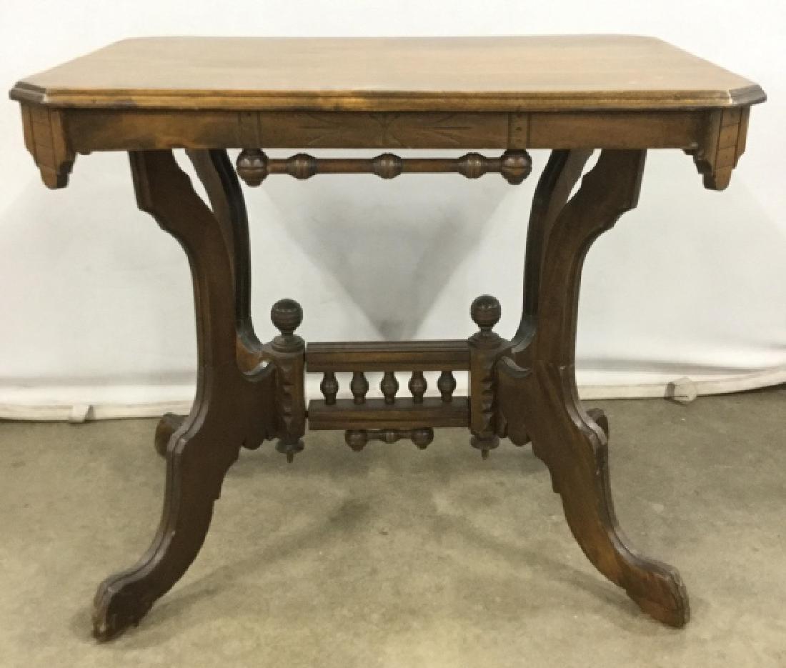 Vintage Carved Wooden Table: Vintage wooden side table w carved wooden design around sides and carved a stretcher with turned wooden details, some minor surface scratches and some Nicks to legs and feet, measures approx 30.5 inch