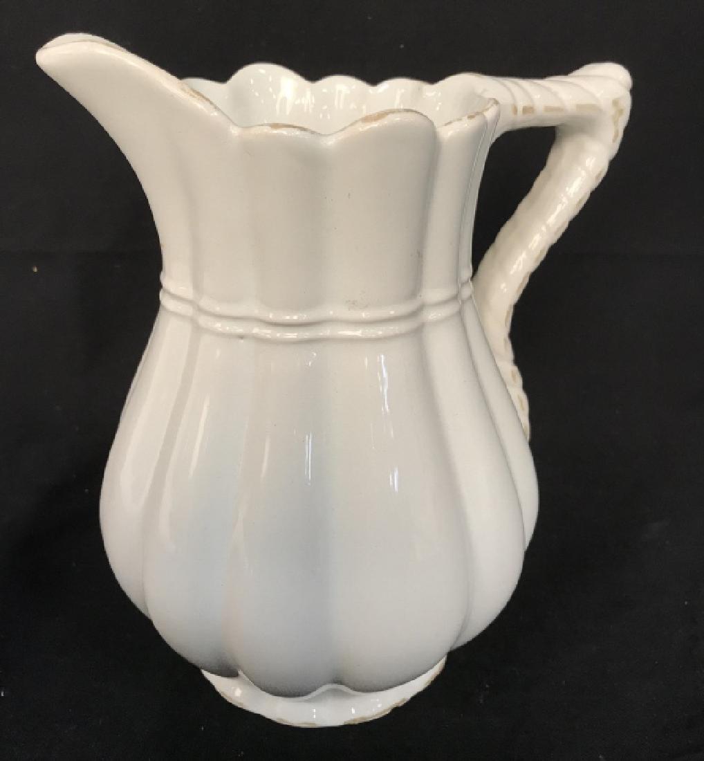 Vintage Signed Ceramic Pitcher: Vintage signed ceramic pitcher. Signed GM on underside. Pitcher is off white in tone. Rustic country home decor. Some minor chips in glaze. Approx 8.5 inches in height by 7.25 inches in width from han
