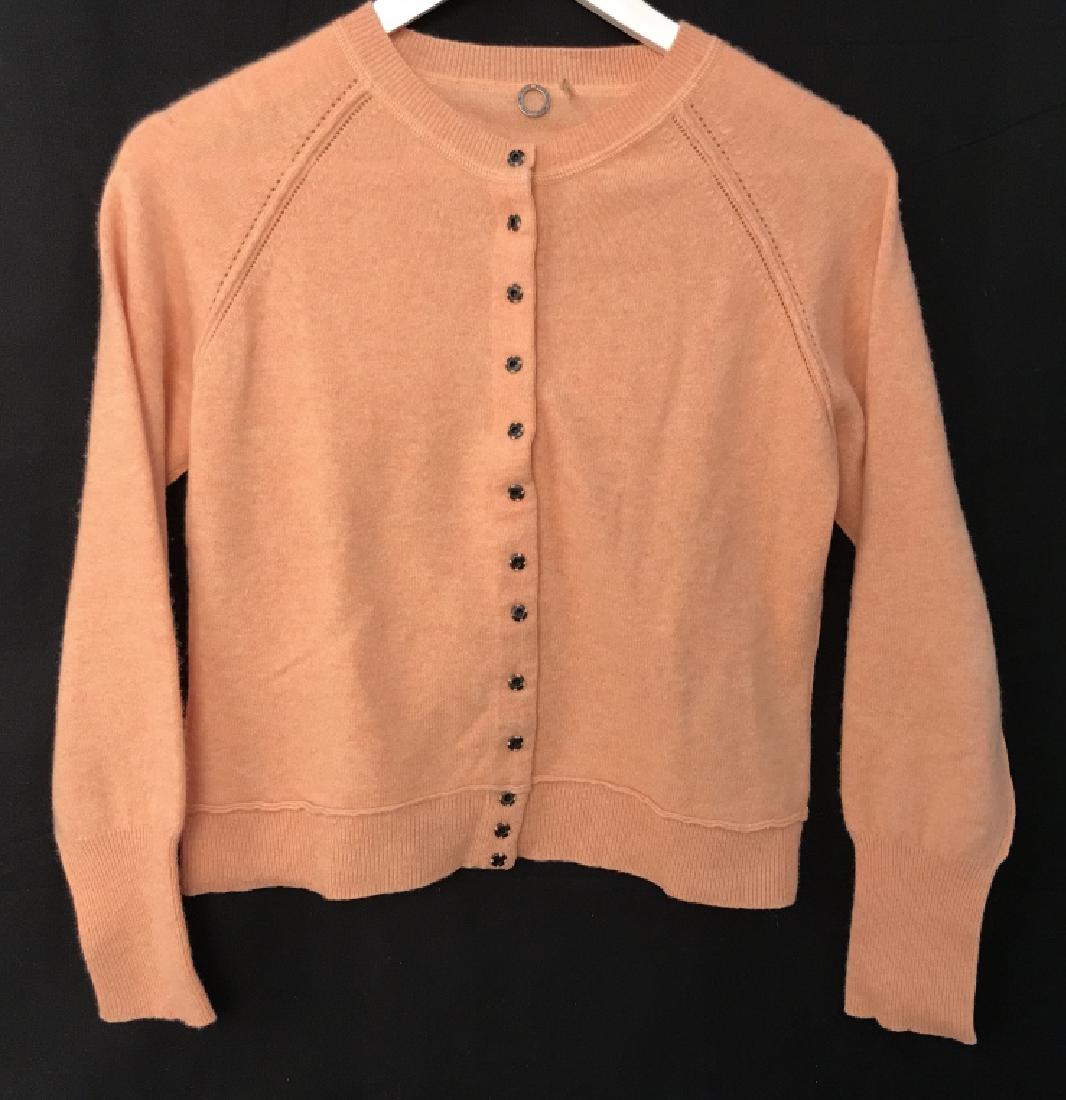 ONE GIRL WHO Designer Cashmere Button Up Cardigan: ONE GIRL WHO Designer women’s casual cashmere button up cardigan / sweater. Cardigan is pastel orange in tone. Label reads One Girl Who, 100% cashmere, Size L. Women’s ladies’ designer cardigan
