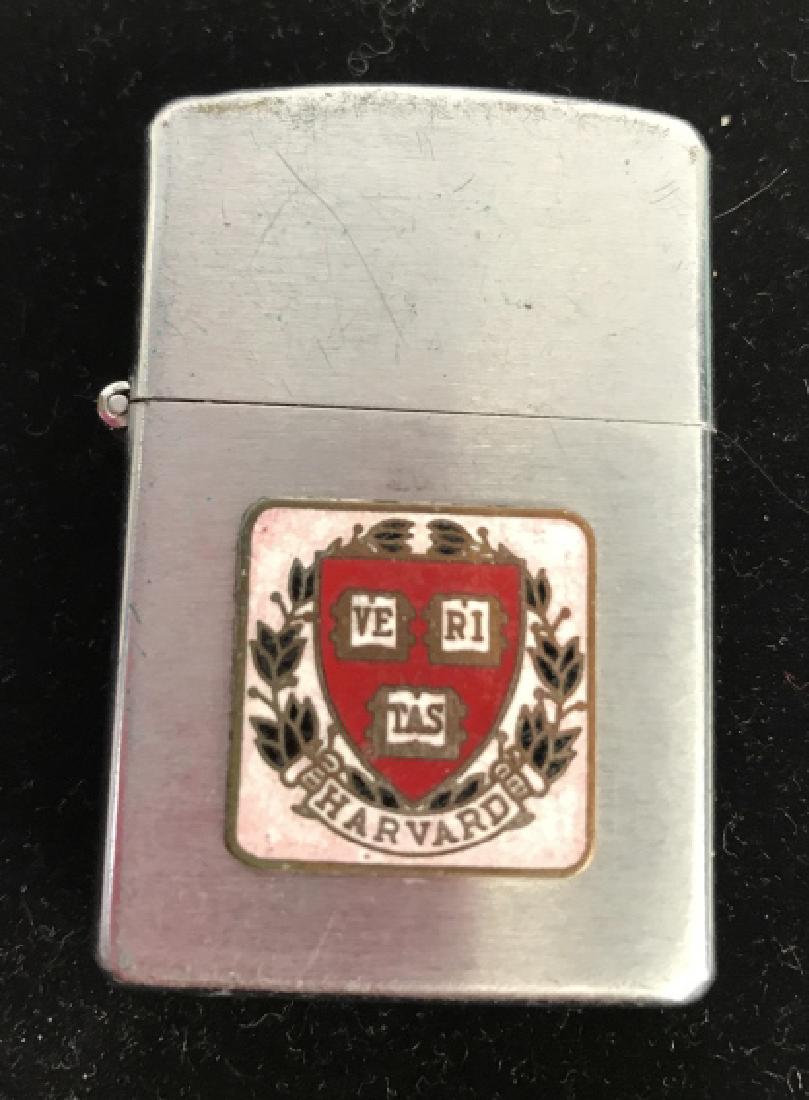 HARVARD Silver Toned Emblem Embossed Lighter: Vintage Lighter Marked for Harvard, marked for Penguin, etched in SAKS Fifth Avenue , University Shop, 75 Mt Auburn Street, Cambridge, Mass, made in Japan numbered 19519, vintage Lighter , Harvard uni