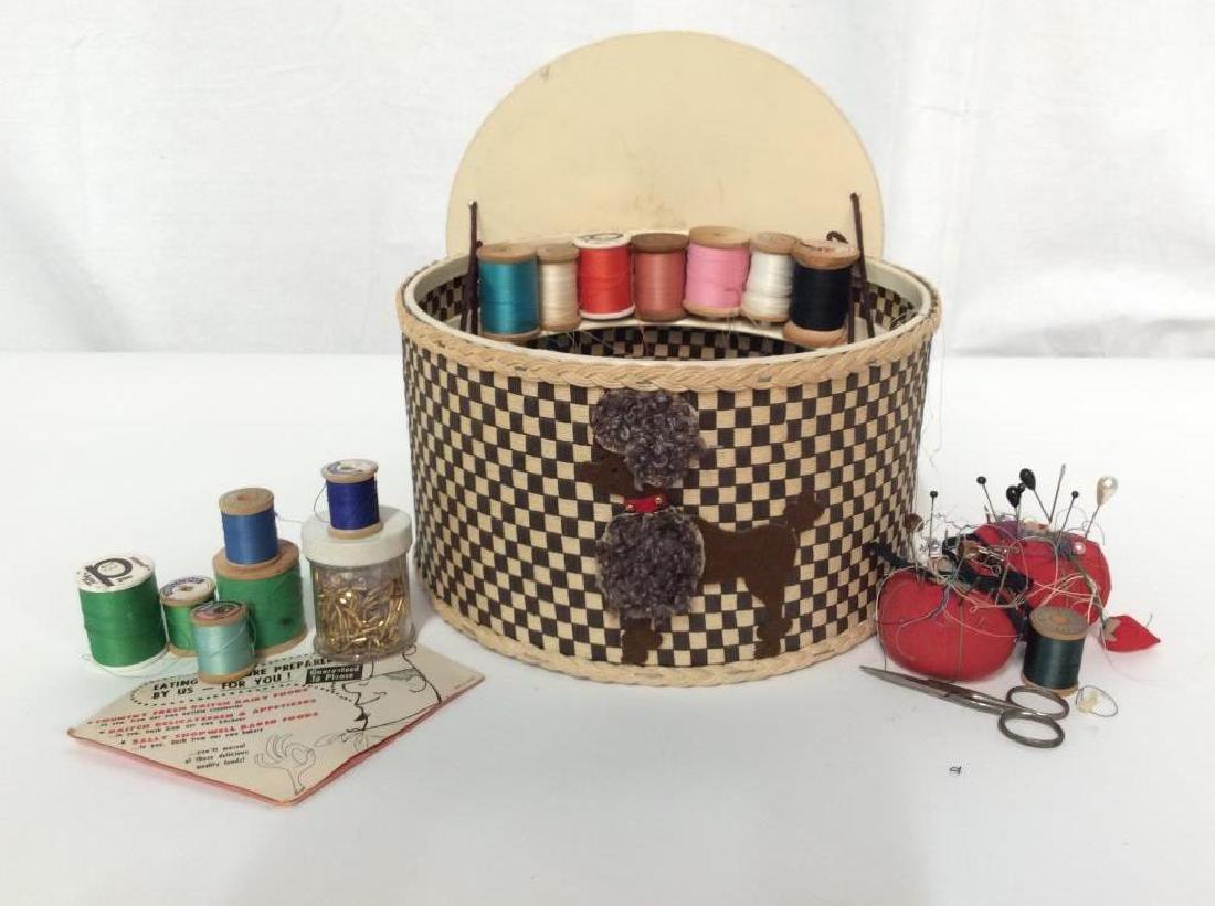 Poodle Embossed Sewing Basket w Accessories: Textured woven circular basket with hand crafted fabric felt poodle decor, inside basket are many spools of threads, pin cushions, stock pins, needles, beads, scissors, hooks, clasps, safety pins and 