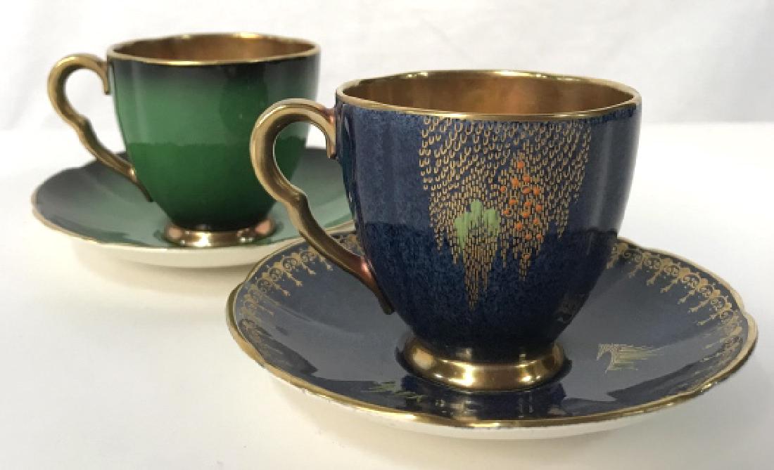 Lot 2 CARLTON WARE Tea cups and Saucers, England: Lot 2 of Carlton ware pottery tea cups and saucers. One set has the blue stork pattern, the other set is vibrant emerald green in tone. Both sets have gold tone details and cup interiors. Signed on un
