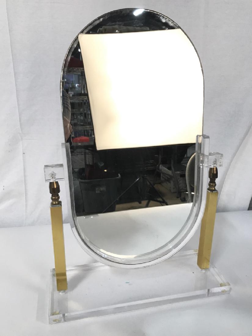 Charles Hollis Style Lucite & Brass Vanity Mirror: This vintage mid century modern brass toned metal and lucite vanity mirror in the style of Charles Hollis Jones is circa 1970. The elegant minimalist design features clean geometric lines; with a fram