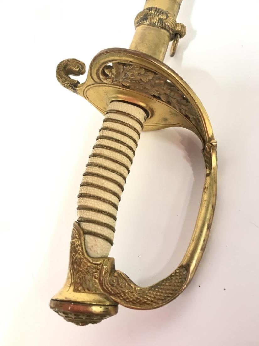 World War II Sword & Sheath: Possibly World War II Sword & Sheath. Sword appears to be brass and metal. Cavalry sword, war sword, Officer sword. Sword has gold toned handle and gold toned elements on sheath. Measures approx 36 in