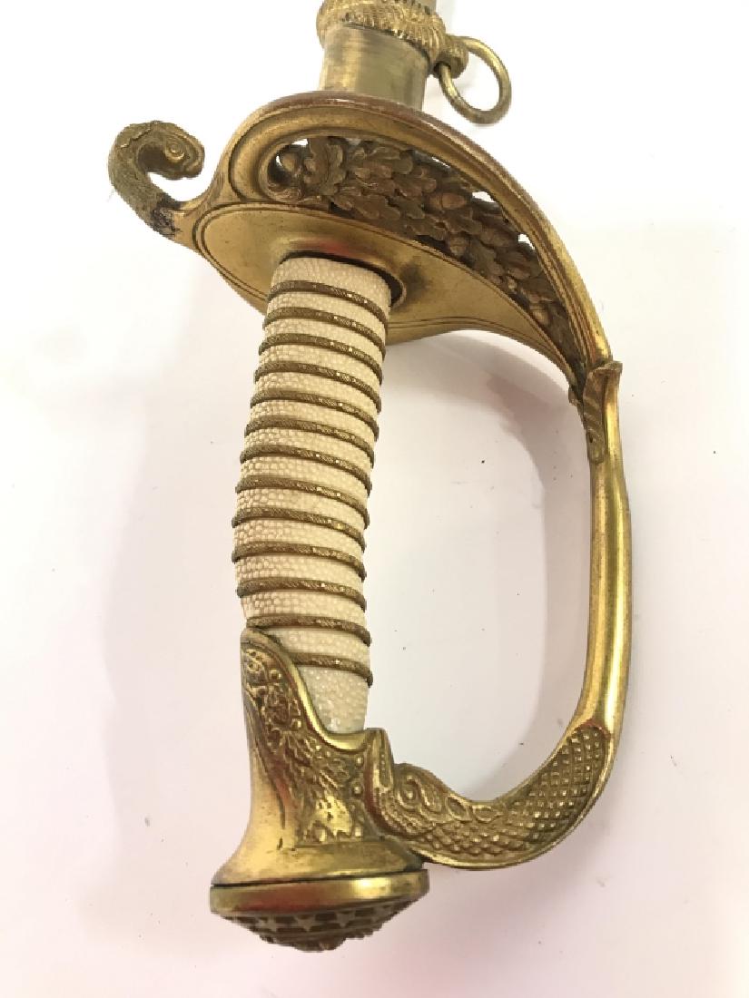 World War II Sword & Sheath: Possibly World War II Sword & Sheath. Sword appears to be brass and metal. Cavalry sword, war sword, Officer sword. Sword has gold toned handle and gold toned elements on sheath. Measures approx 38 in