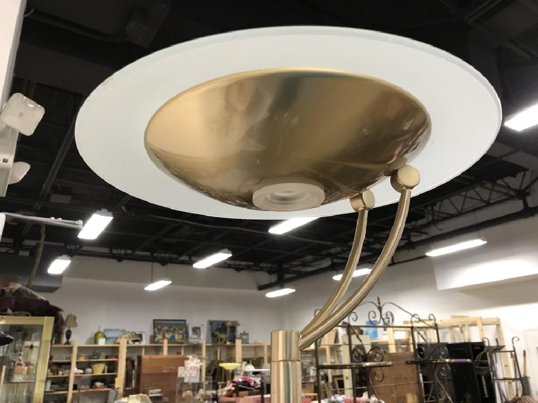 Gold Toned Metal Floor Lamp: Floor lamp is gold toned, has circular base & top. Measures approx 72 inches tall 12 inches wide. Has not been tested. In good structural condition. Home lighting, standing floor lamp, home accessory.