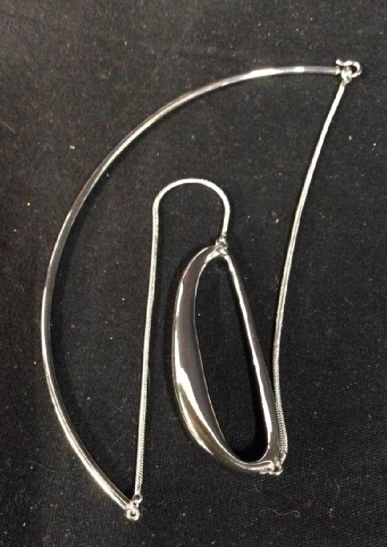 Silver Toned Tubular Nacklace: With elliptical pendant measures app 2.5 inches length drop from double clip center back app 7.5 inches, vintage jewelry, estate jewelry, fashion accessory,