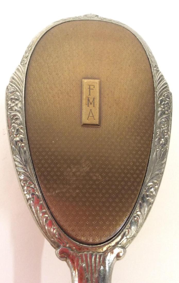 Silver Toned Vintage Vanity Brush: Brush Is vintage possibly antique. Brush is silver And gold toned. Contains some ornate detail. IS marked FMA on backside. Measures approx 10 inches long 3.25 inches wide. Tabletop dresser vanity acce