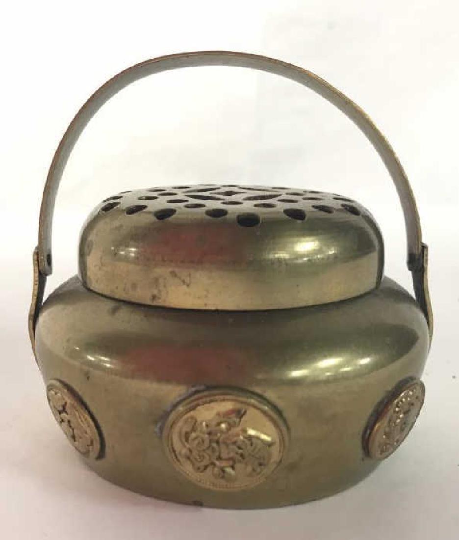 Antique Brass Censer W Handle: Censer is gold toned and brass. Censer is lidded. Lid has pierced geometric detail. Censer has handle. Measures approx 3 inches tall 3.5 inches wide. Censer, incense burner, vessel, 6.