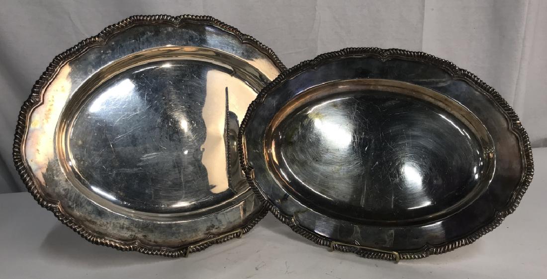 Lot 2 Sheffield Silver on Copper Platter Trays: Lot 2 Sheffield silver on copper serving platter trays. Marked for Sheffield on undersides. Scalloped rope edges on oval shaped platters. Larger platter measures approx 16.75 inches By 12 inches in le