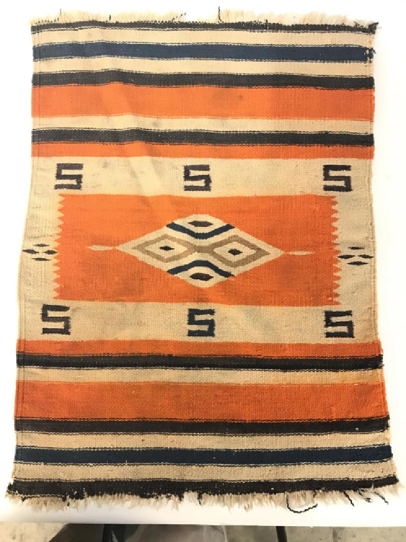 Antique Navajo Blanket Fragment: Piece is handmade, appears to be wool. Contains tones of orange, beige, navy, and dark brown. Has fringes at edges. Measures approx 18 inches wide 25 inches long. Wall hanging, tapestry, throw rug, ho
