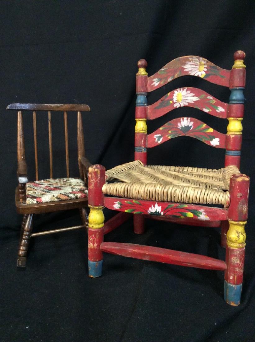Lot 2 Collectible Doll’s Chairs: Lot 2 Wooden Dolls Chairs Collectible, one dark brown toned wooden dolls rocking chair with hand woven seat cushion bolted to seat, one red toned painted wooden chair with hand painted floral design a