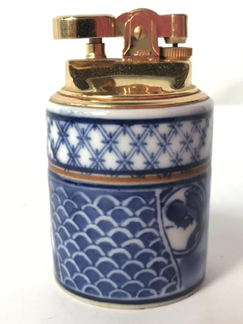 PENGUIN Vintage Asian Porcelain Lighter: Piece is porcelain. Contains geometric detail. Top of piece reads PENGUIN. Underside appears to have Asian Characters, asian arts and crafts, collectible lighter, porcelain accessory . Measures approx