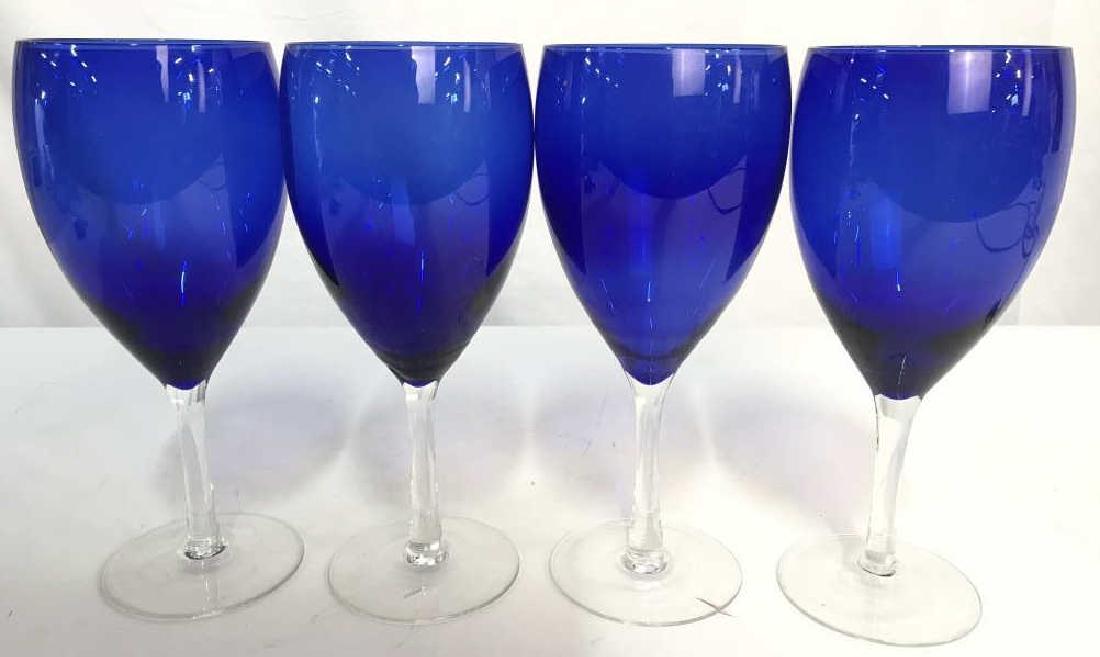 Set 4 Blue Toned Art Glass Wine Glasses: Pieces are possibly hand blown. Each basin is blue toned. Stems are clear. Each measures approx 8.5 inches tall 3.5 inches wide. Stemware, Wine Glasses, Blue stemware, blue wine glasses, blue cocktail
