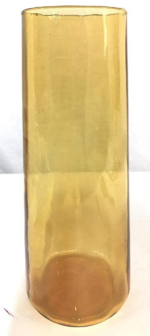 Amber Toned Glass Vase: Vase is glass and amber toned. Piece starts wide at bottom and tapers in gradually to top. Measures approx 11 inches tall 5 inches wide. Glassware, art glass vase, vessel, tableware, Tabletop accessor