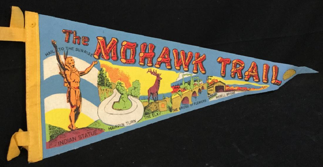 The Mohawk Trail Collectible Pennant: Collectible pennant flag of the Mohawk Trail. Flag depicts different illustrated scenes of the trail. Measures approx 26 inches in length by 8 inches in height. Some surface wear of flag consistent wi