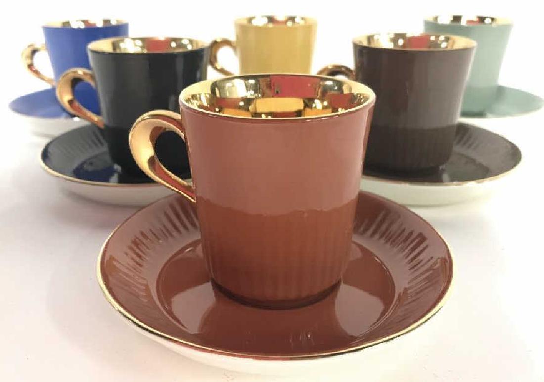 Lot 12 FIDDJO FLINT NORWAY Porcelain Cup & Saucer: Underside of each piece reads FIDDJO FLINT NORWAY. Lot includes 6 unique colors including brown, light brown, yellow, green, dark grey, & blue. Inner portion & handle of each is copper toned. Saucers 
