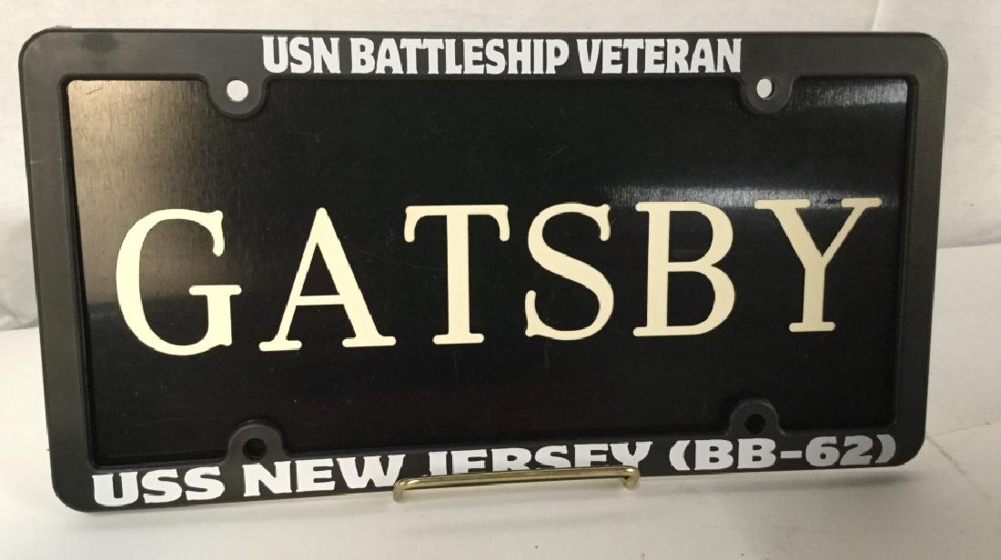 Decorative ‘Gatsby’ License Plate: Decorative ‘Gatsby’ license plate. Plate is black in tone with white lettering. Plate is plastic. Some minor / subtle surface wear. Measures approx 6.25 inches in height by 12.25 inches in width. 