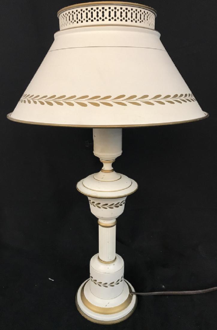 Vintage Cream Toned Metal Lamp: Lamp is cream toned with gold toned leaf and vine accent detail. Shade is also metal. Measures approx 20 inches tall 5 inches wide without shade. Table Lamp, home accessory, home lighting 6.