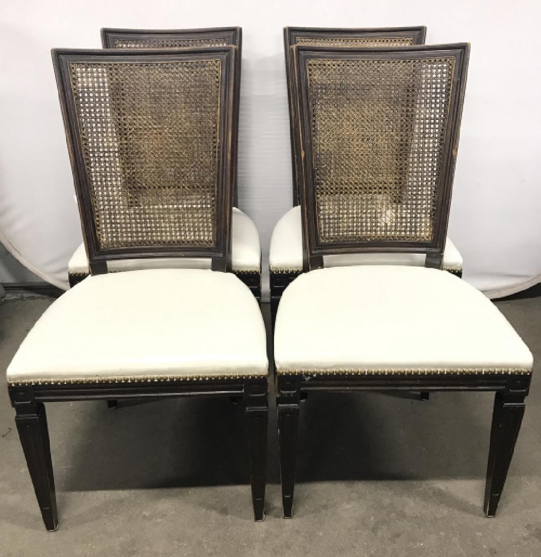 Set 4 Vintage Caned Side Chairs: Lot includes 4 side chairs. Chair frames are wooden. Chair seats have cushions upholstered with possible genuine leather and is white toned. Back rests are caned. Each measures approx 38 inches tall 2
