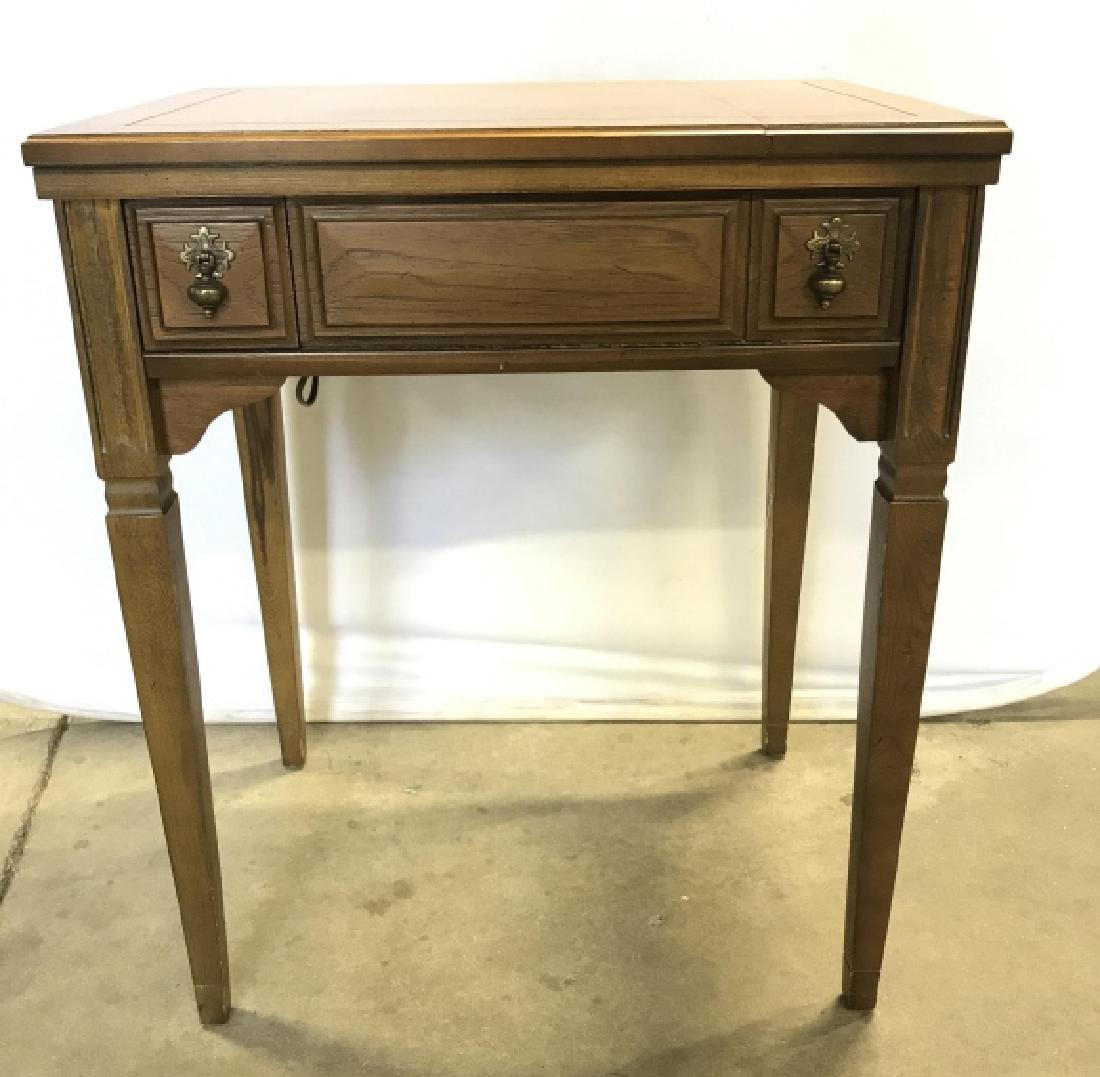 Vintage Singer Sewing Machine Convertible Table: Vintage Sewing Machine Table With Brass Toned metal hardware and tapered legs, folds open to reveal a Singer sewing machine, closes down to become a side table, measures approximately 25.5 inches wide