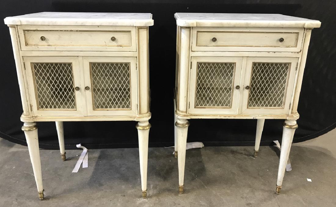 2 Vintage Marble Top Carved Wooden Nightstands: Nightstands are possibly antique. Each are carved wood, cream toned, with 4 legs, drawer and cabinet doors. Both have white toned marble tops and gold toned accents. Drawers appear to have hand doveta