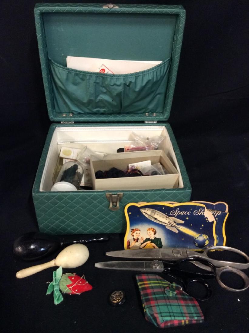 Sewing Kit W Needles, Buttons and More: Sewing Kit W Needles, Buttons and More. Teal toned diamond patterned fabric box with buttons, bins, sock darners, fabric scissors, buttons, pin cushions and more. Box measures approx 5 in by 10 in by 