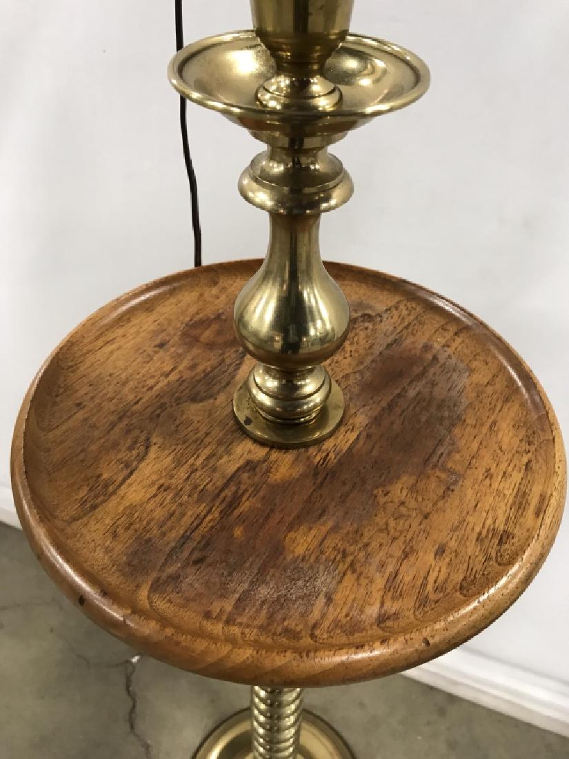 Brass Toned Pedestal Floor Lamp with Small Table: Brass Toned Pedestal Floor Lamp with Table, overall height 57 in, with 10 in table top diameter, formed as a single brass toned graduating bulb stem, with light wood round top, from which a candle and