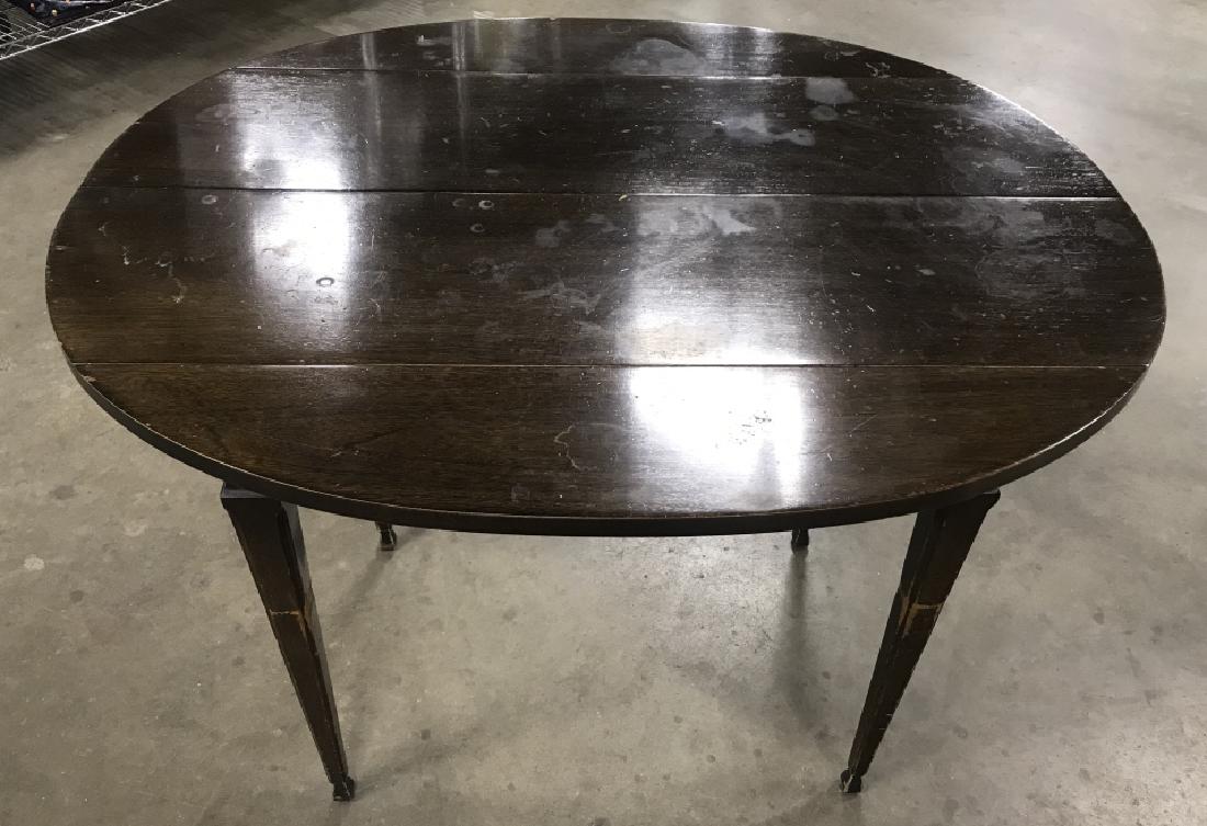Vintage Dark Wooden Drop Leaf Extendable Table: Vintage dark wooden drop leaf table. Table has oval shape when propped up fully. Table can be extended, 3 extension boards included. Tabletop Measures approx 38.2 inches by 31.8 inches in length and w