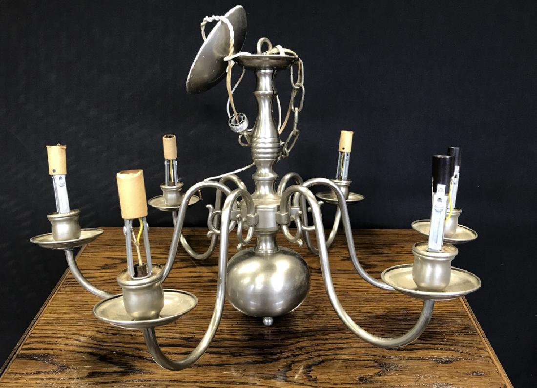 Six Arm Chandelier In Silver Toned Metal: Six Arm Chandelier In Silver Toned Metal with delicate curved arms, decorative center column and candelabra lamps. Home Lighting. Dining room lighting. Hanging Ceiling Lights. Chandelier. Some cracks 