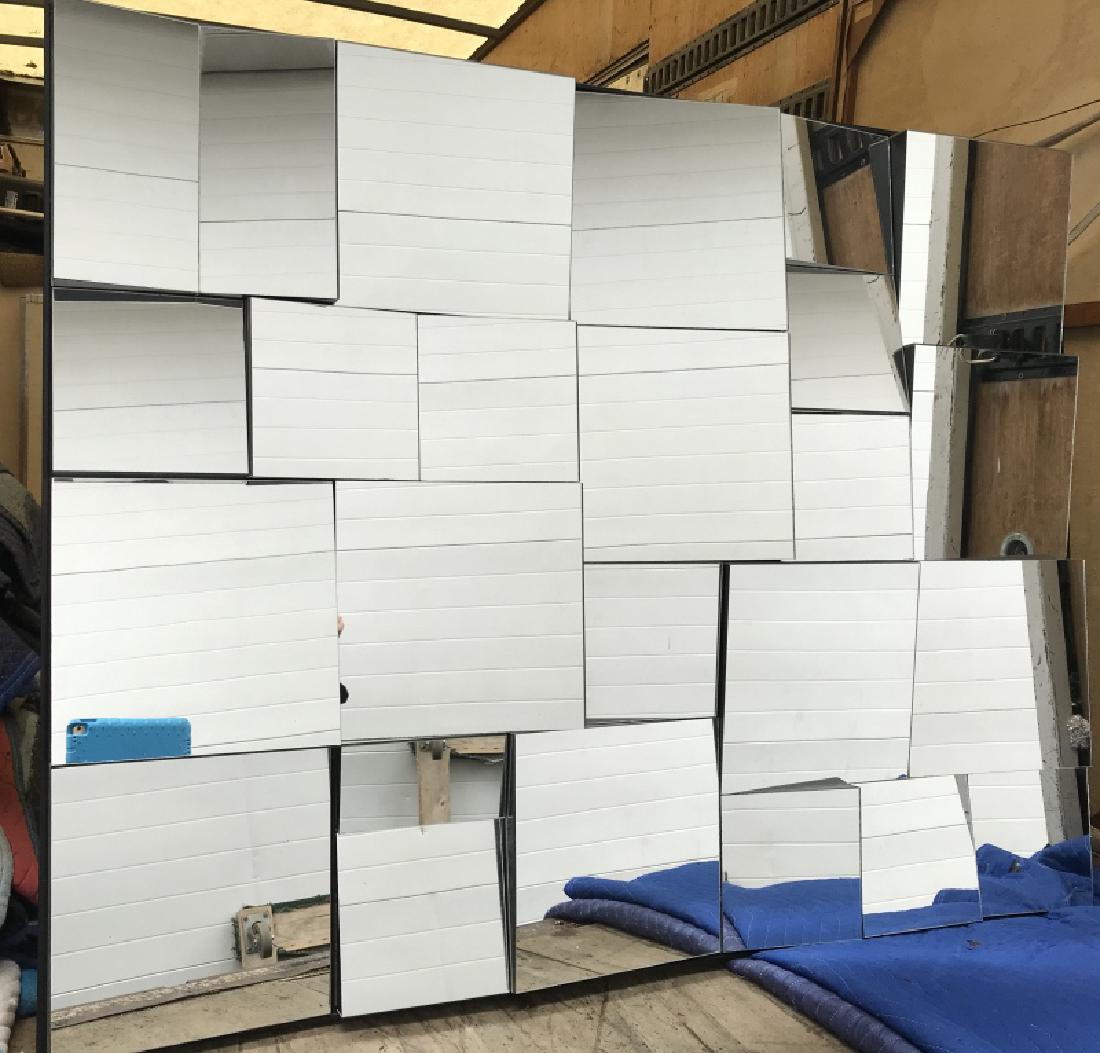 1970s Multifaceted Mirror attributed to Neal Small: Multifaceted mirror / wall sculpture attributed to designer Neal Small, c. 1970s. Multifaceted mirrors are mounted on black painted wood frame and backing. Mirror measures approx 45 inches in height b