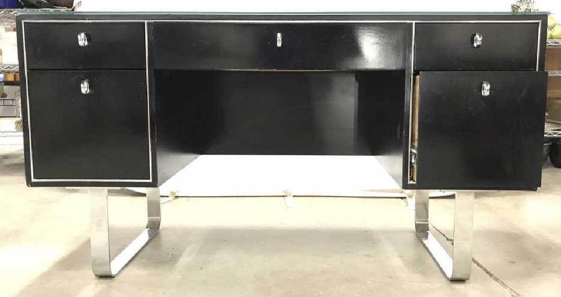 JOHN STUART INC Glass Top Mid Century Modern: Tag reads JOHN STUART INC GRAND RAPIDS NEW YORK. Desk is black toned and wooden. Lower half has 2 chrome legs. Desk has 5 drawers. Each with chrome loop style handles. Piece has glass top. Drawers app