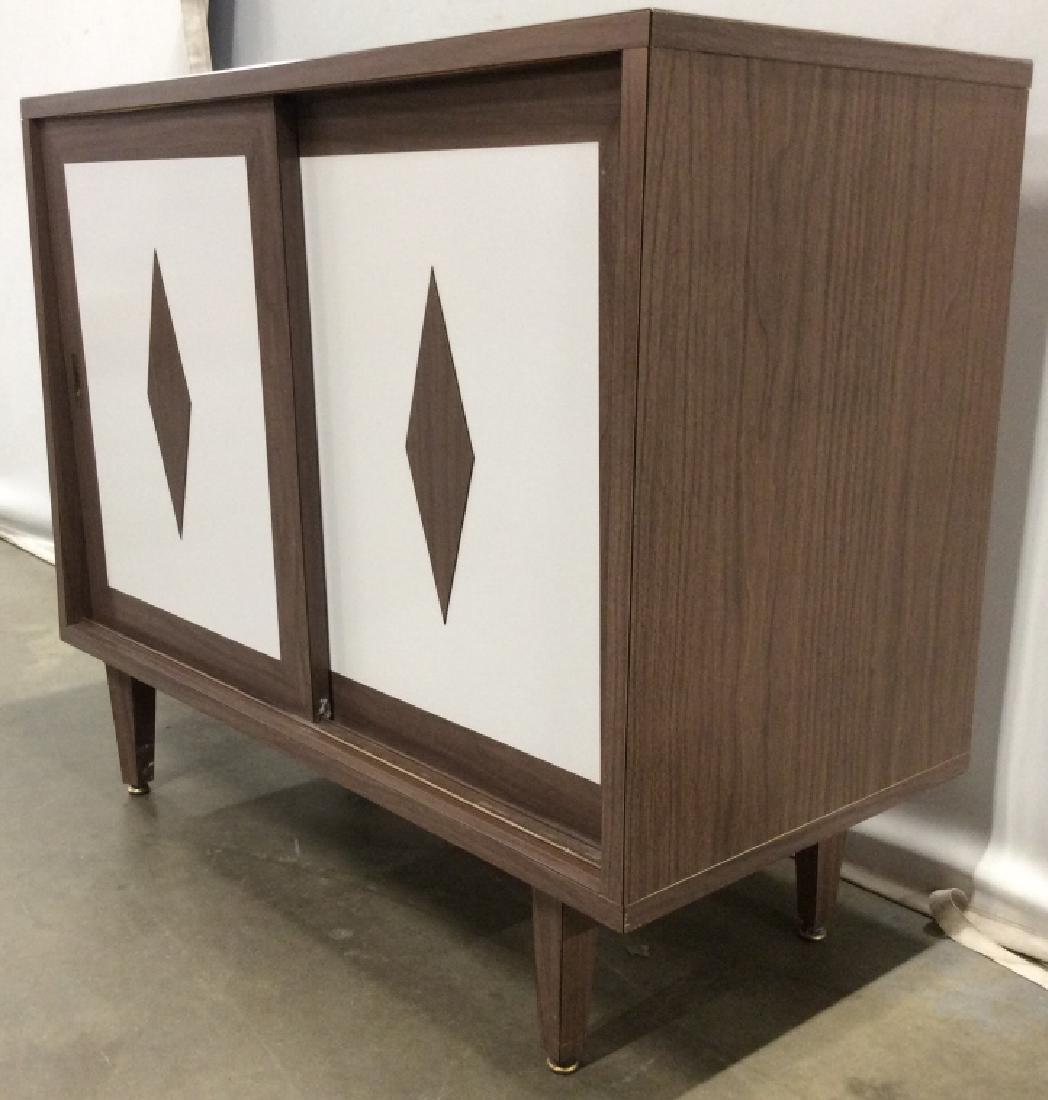Authentic Mid Century Modern Sliding Door Cabinet: Cabinet has 2 sliding doors. Piece has tones of white and brown. Has diamond shaped wooden detail on doors. Authentic Mid Century Modern Cabinet, mid Century Modern Style Cabinet, mid Century Modern F