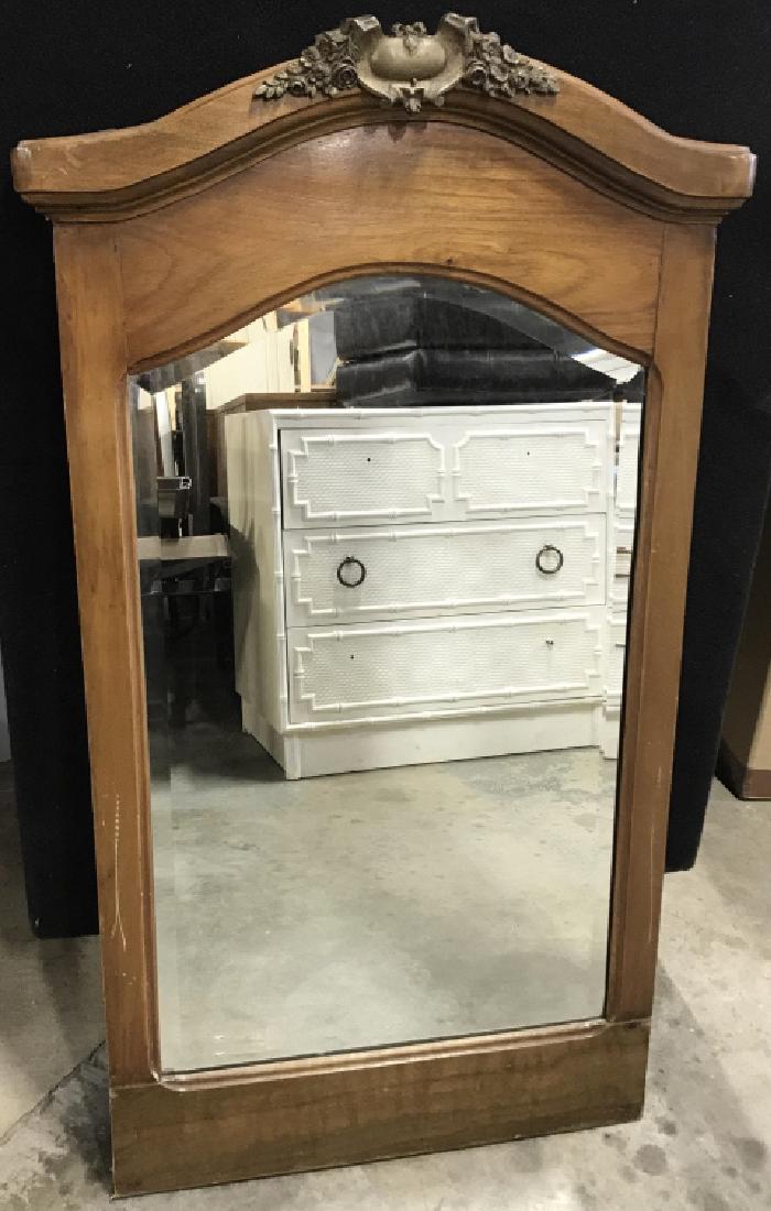 Wood Framed Pier Mirror W Brass Toned Emblem: Vintage, possibly antique, Wood framed pier mirror with brass toned metal emblem paque detail at the top. Mirror is beveled. Measures approx 40 inches in height by 20.75 inches in width. Some scuffs o
