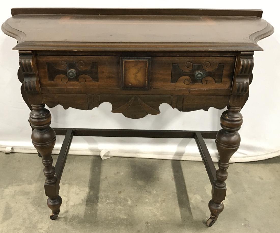 Antique Side Table On Caster Feet: Vintage Possibly Antique Side Table With turned front legs, Caster Feet, and single drawer with carved detail and two metal drawer knobs, measures approximately 40 inches wide x 18 inches deep x 29 in