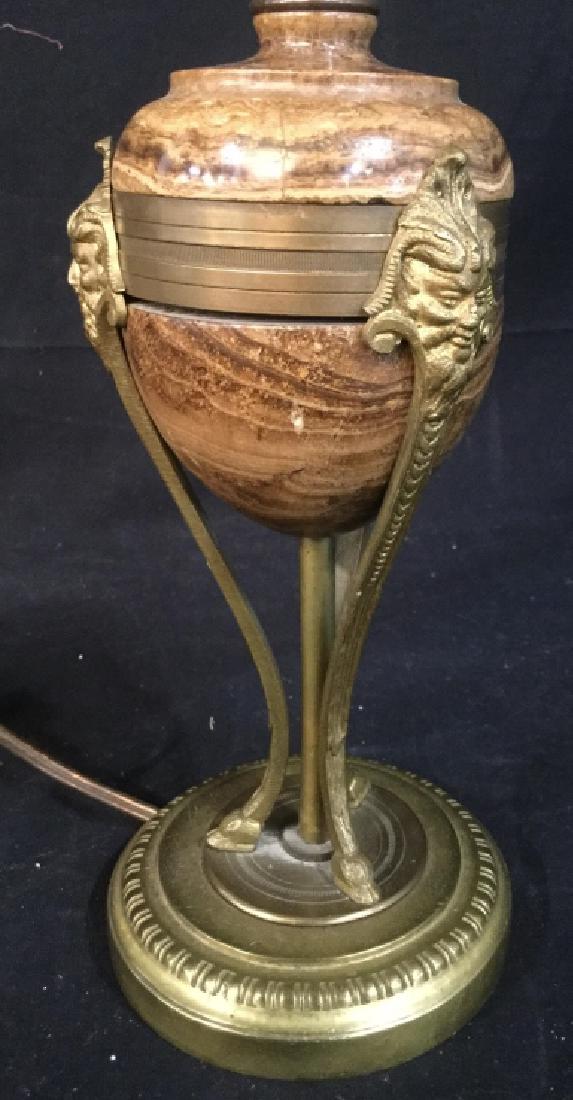Antique Gilded Bronze Marble Cassolette Lamp: Possibly French Art Nouveau Style Lamp, Double Light with Carmel Toned marble orb, gilded Bronze gargoyle faces, sinuous tripod legs ending in hoof feet,measures ht app 16.5 inches, diameter app 4.5 i
