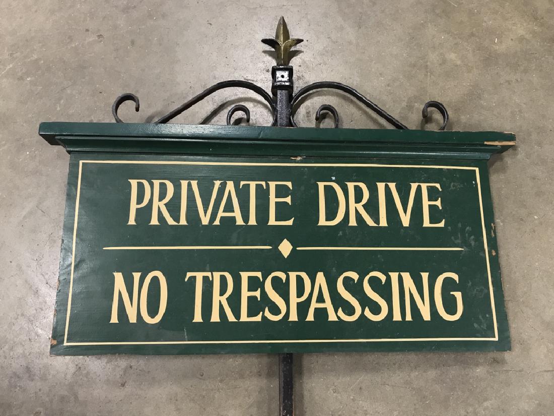 No Trespassing Wood Sign On Iron Spear: Private Drive No Trespassing on painted green wooden sign. Sign is attached to iron spear / spike. Measures approx 53 inches in height by 27 inches in width. Some surface wear consistent with exposure