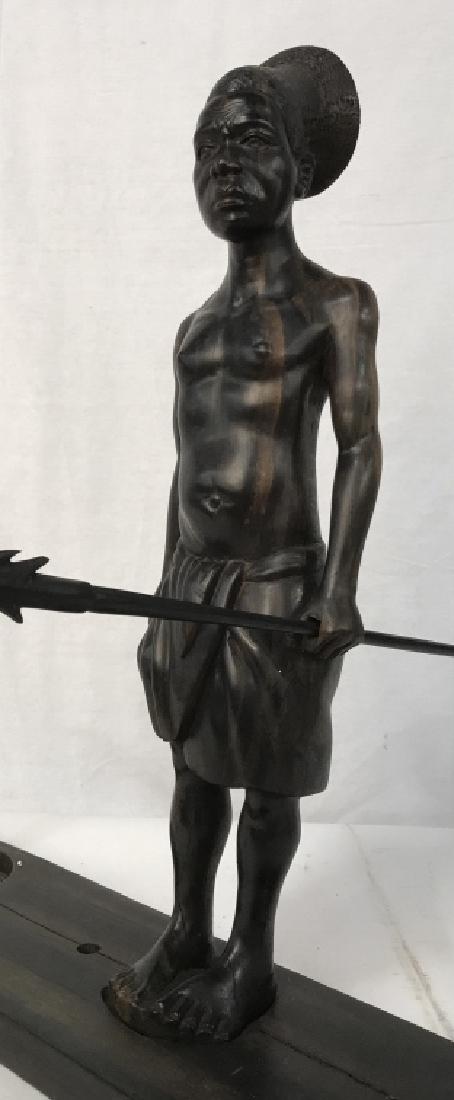 Carved African Warrior Figural w Spears Stand: Carved wood sculpture, possibly African , in Tribal Wear, fitted into carved Wood Stand, two carved wood spears in slots or fitted to hand, wood carving, arts and crafts, tribal warrior, measures ht a