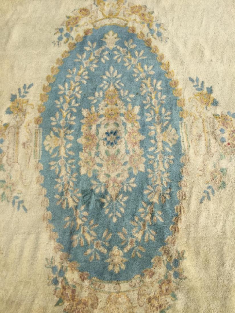 Handmade Floral Detailed KERMAN Rug: Tag attached to rug reads KERMAN. Contains floral detail with tones of beige, olive, light blue, green, coral. Contains fringes. Measures approx 147 inches long 104 inches wide. Home accessory, home d