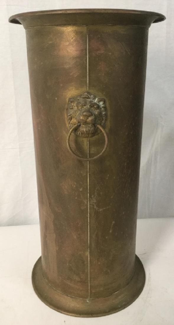 Gold Toned Brass Fireplace Tool Stand: Fireplace tool stand is gold toned and brass. Can also be re purposed as umbrella holder. Contains beveled lion head Detailed handles. Measures approx 22 inches tall 10.5 inches wide. Decorative acces