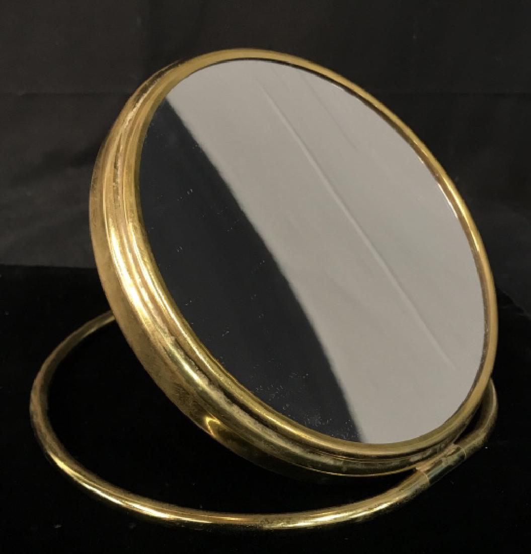 Vintage Brass Vanity Magnification Mirror: Vintage Brass Double Sided Vanity Magnification Mirror, one side is a closeup mirror and the other is normal magnification, Measures approx 8.5 in diameter, brass needs polishing. Tabletop Vanity Mirr