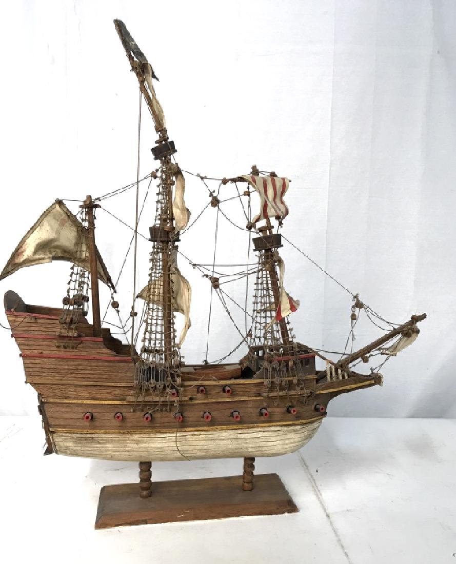 Large Scale Wood Fabric Twine Pirate Ship Model: Hand crafted hand constructed wood model of a ship, skull and cross bone flag, pirates ship, folk art, vintage possibly antique, raised on rectangular wood stand, measures ht app 33 inches top of mast