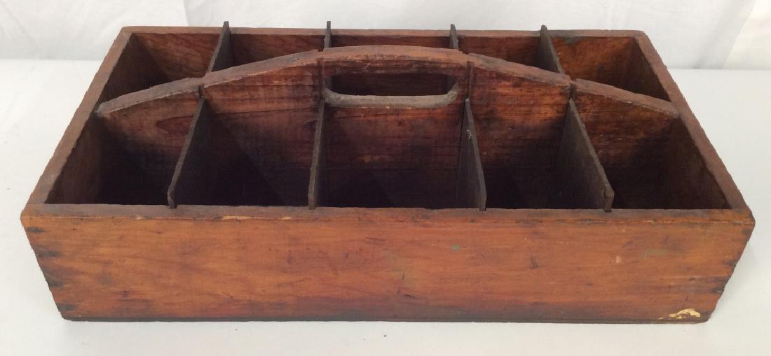 Antique Carpenters Wooden Toolbox Caddy: Antique carpenters wooden toolbox with center handle and 10 compartments with removable slots. Measures approx 6 inches in height by 19 inches in width by 10 inches in depth. Box has surface wear cons