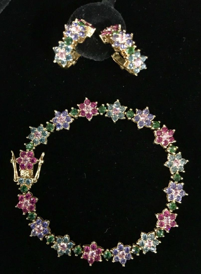 Set 3 Joan Rivers Colored Crystal Glass Bracelet: Set 3 Joan Rivers Colored Crystal Glass Bracelet And Earings with gold toned metal base and pink, purple, and green toned rhinestone crystal glass flower design, marked on reverse of Earrings Joan Riv