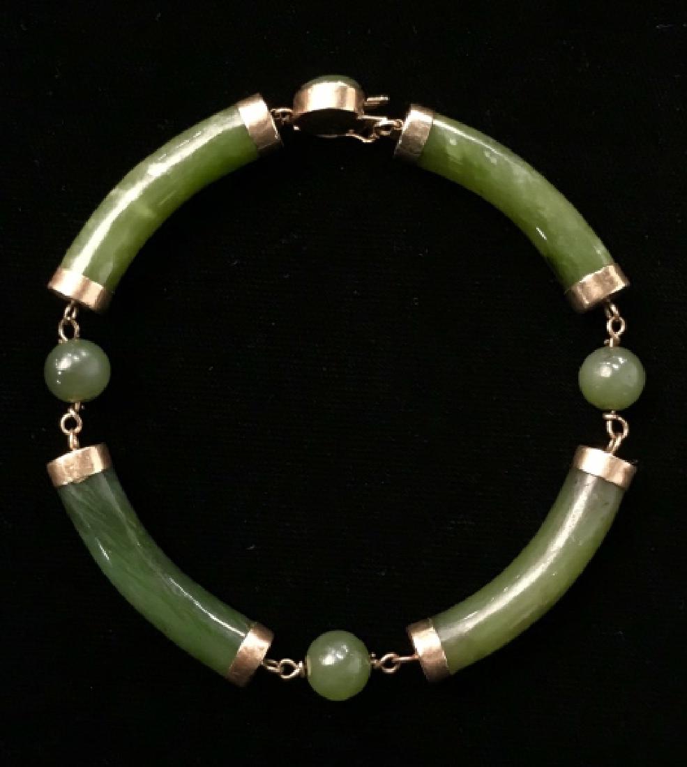14 K Gold And Possibly Spinach Jade Bracelet: 14 K Gold And Possibly Spinach Jade Bracelet with chain Link accents and box clasp, marked on clasp 14K, Measures approx 8.5 inches long x .25 inches wide. Spinach Jade, Nephrite, Green Toned Stone An